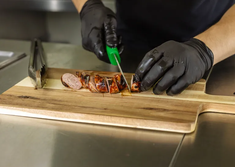 Freshly grilled meat being sliced to order