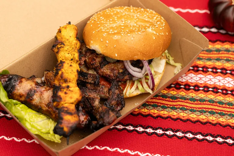 BBQ Playground sandwich filled with fire-grilled meat and fresh salad