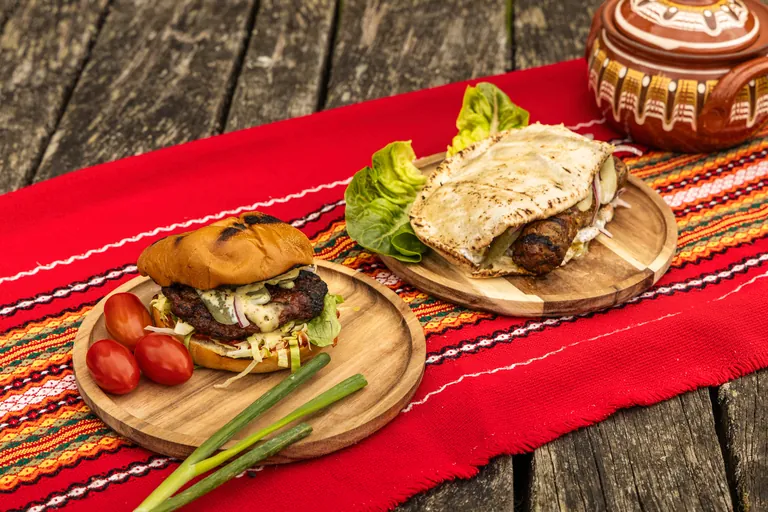 Selection of BBQ Playground dishes on a traditional Balkan tablecloth